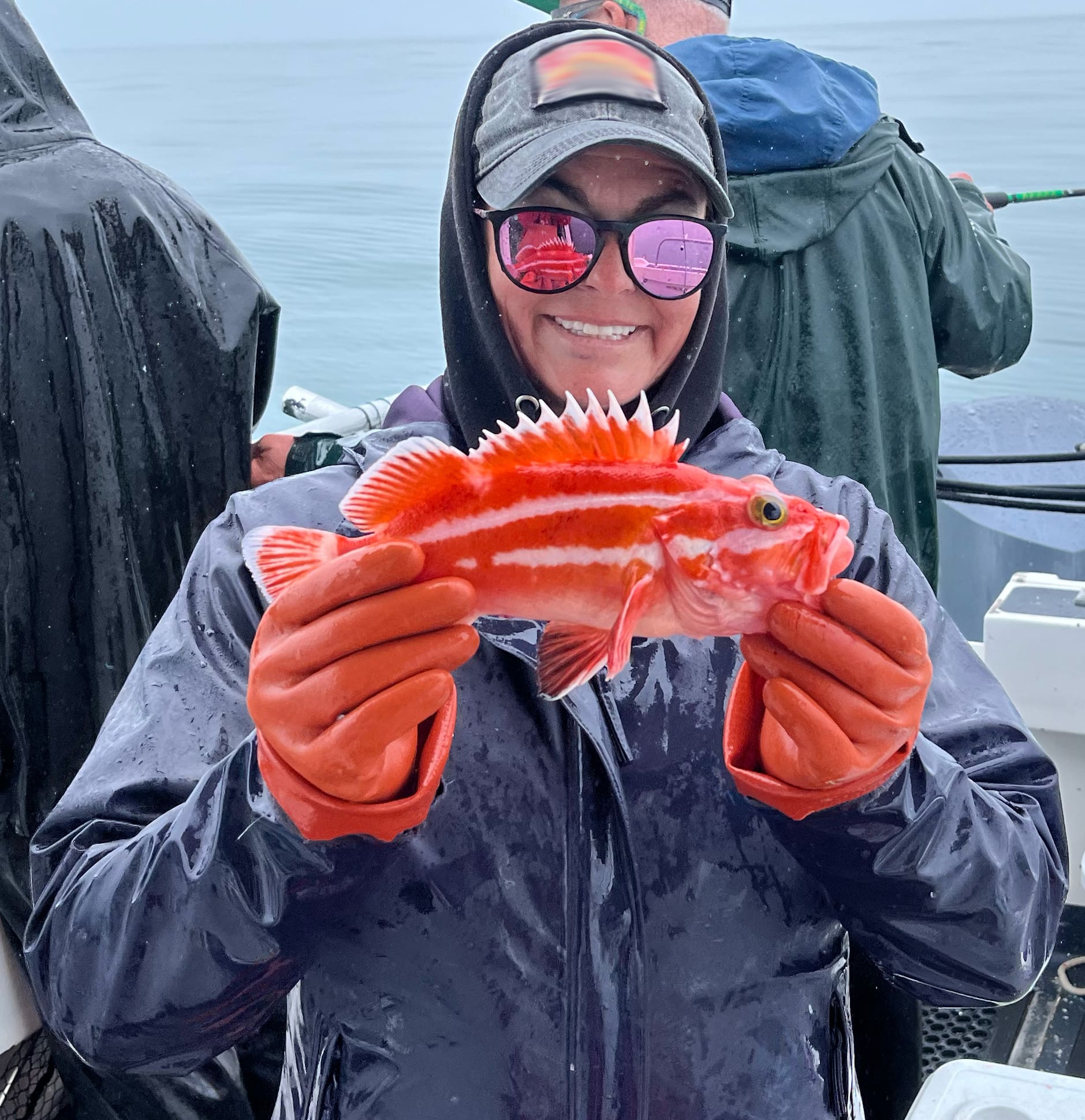 Captain-jojo-holding-a-juvenile-yelloweye-in-the-rain